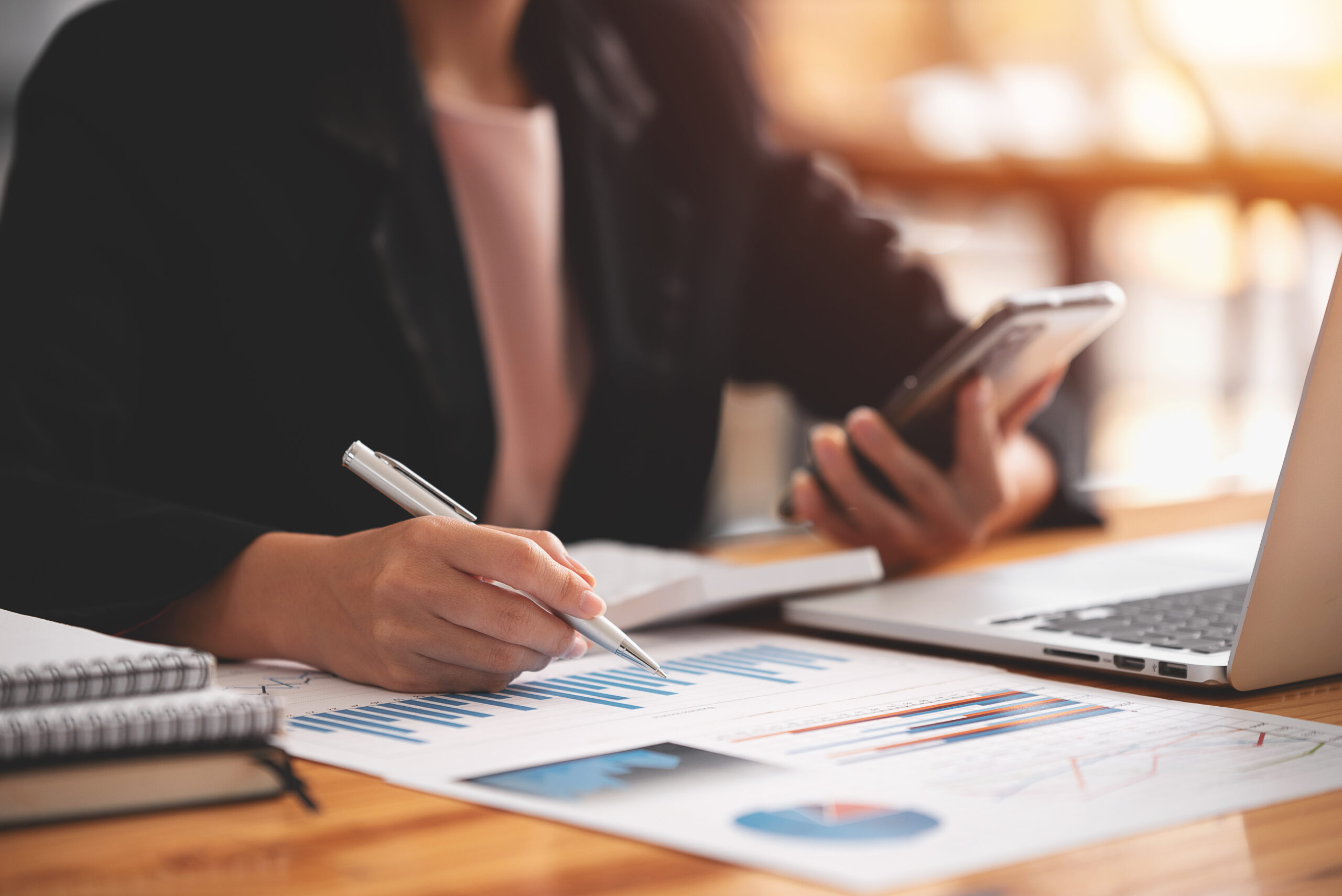 Asian woman sitting at a desk working in the office use a computer, laptop